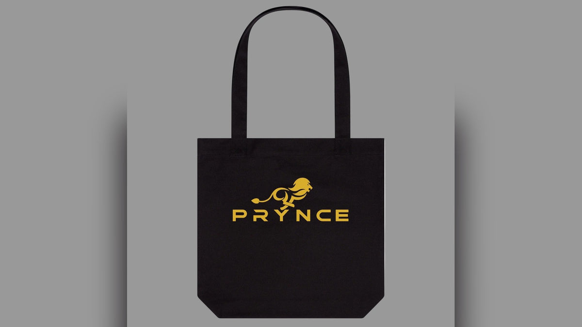 Black PRYNCE Lion Lockup Tote Bag with gold lion and PRYNCE wordmark — PRYNCE Clothing accessories collection
