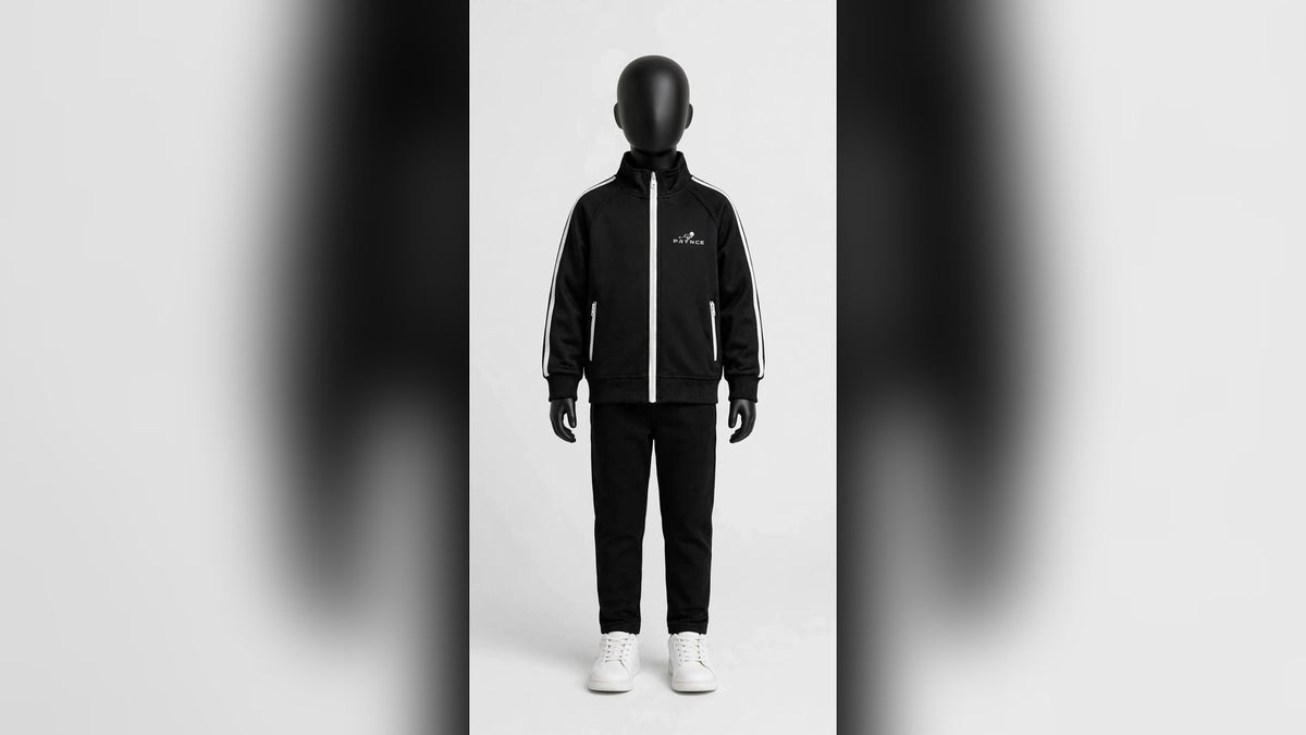 Matte black mannequin wearing a black PRYNCE Cubs tracksuit with white PRYNCE lion logo — PRYNCE Clothing kids collection