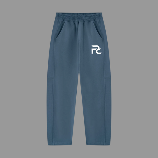 A pair of slate blue sweatpants with a white stylized &