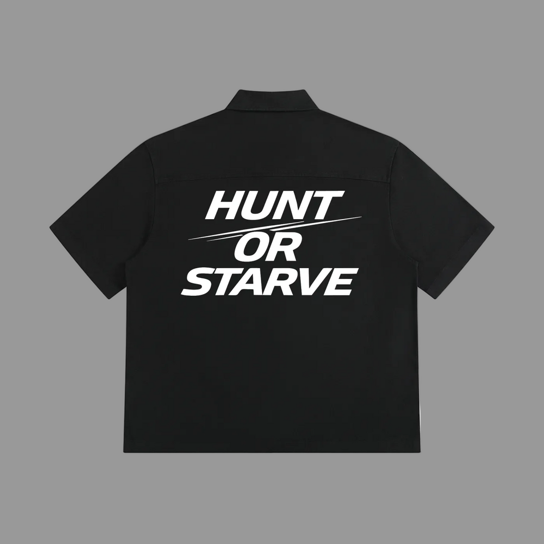 A black short-sleeve collared shirt shown from the back, featuring the slogan &