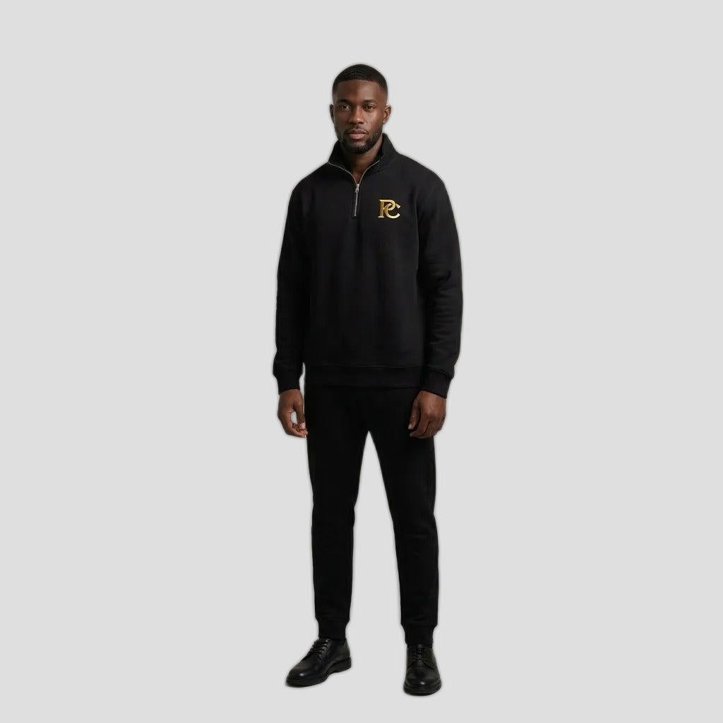 Man wearing the PC Signature Quarter Zip in black with a small gold PC logo on the chest
