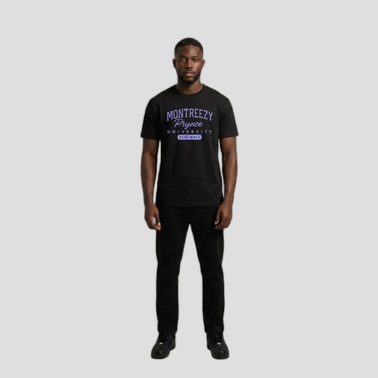 Man wearing the black Montreezy Prynce University Tee with purple collegiate print, full-body studio photo