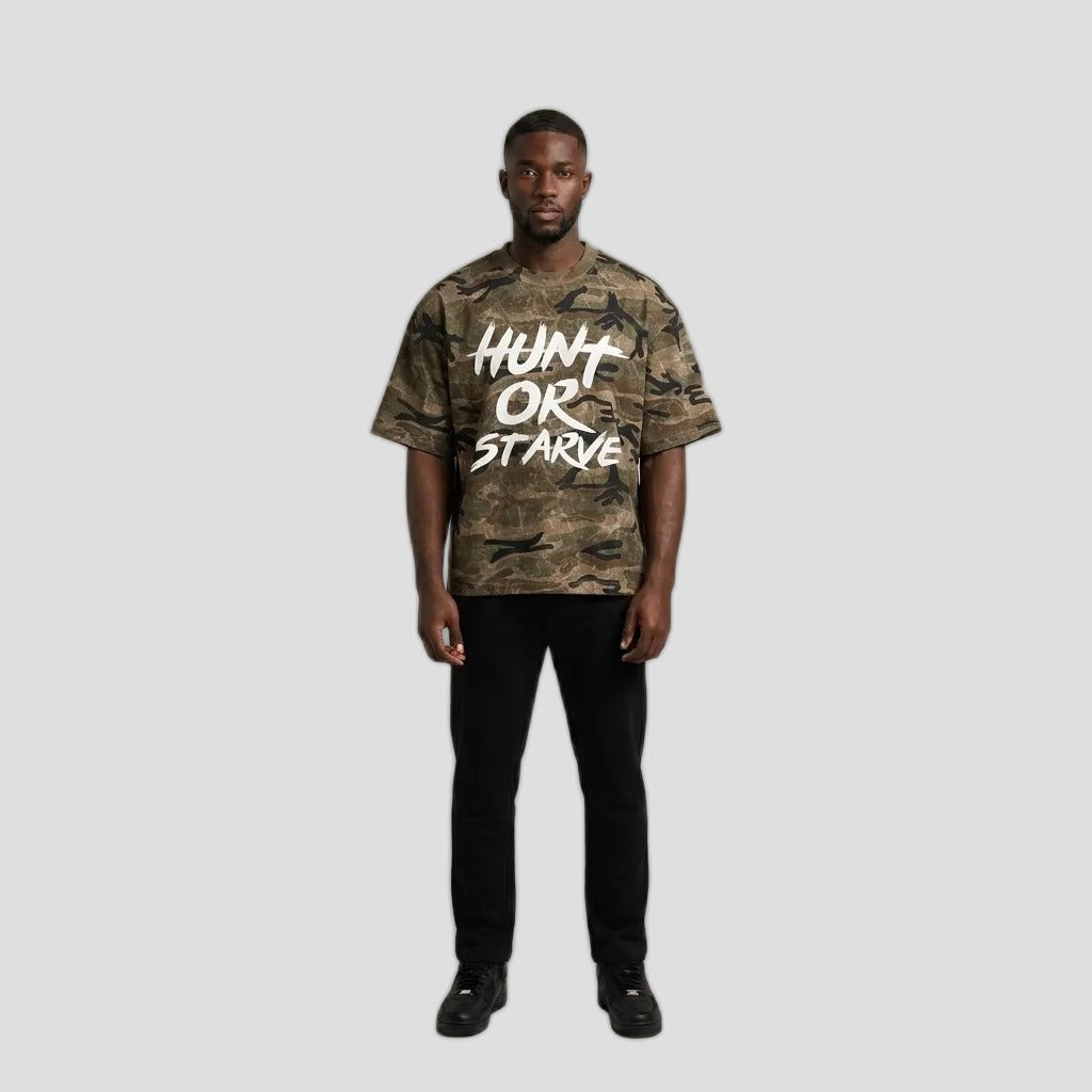 Model wearing the Hunt or Starve Stalker Camo Tee, PRYNCE studio catalog tile
