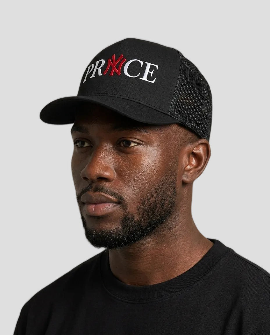 A man wearing a black trucker cap with &