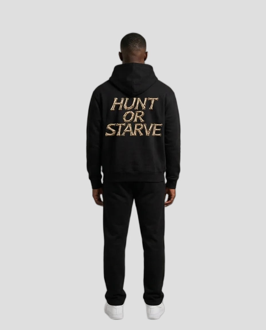A man viewed from the back wearing a black hoodie with &