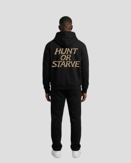 A man viewed from the back wearing a black hoodie with &
