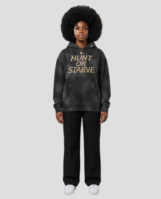 A model wearing a washed black pullover hoodie with &