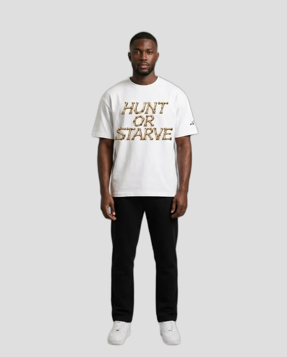 Man wearing the Hunt or Starve Bone Tee in white with tan bone-letter HUNT OR STARVE print