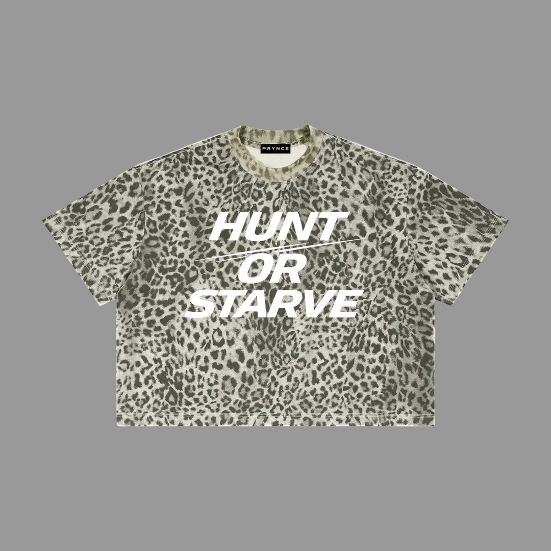 A short-sleeve crop top t-shirt with an olive green and beige leopard print pattern, featuring the text &