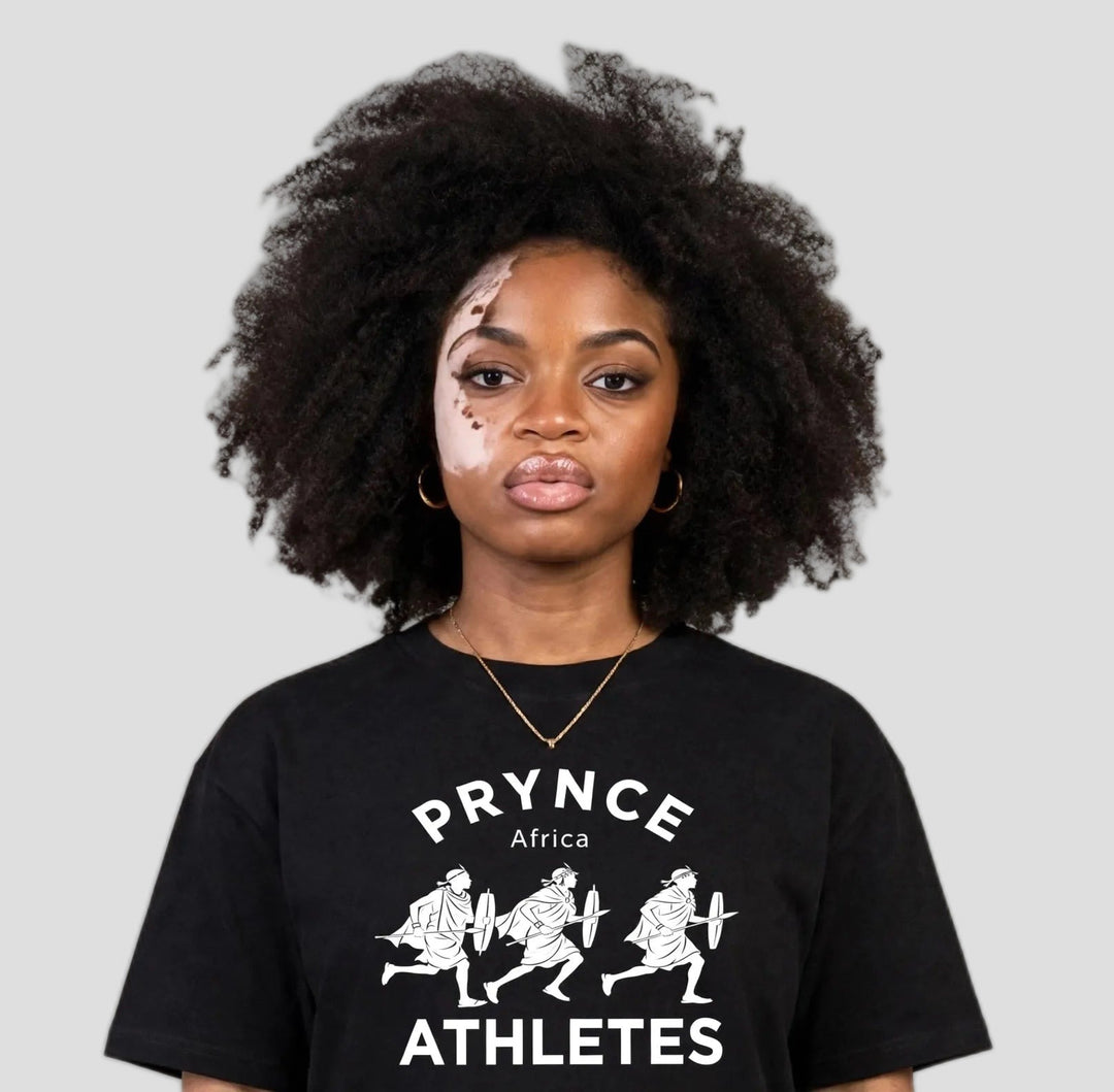 Woman wearing the PRYNCE Maasai Africa Athletes Tee in black with white PRYNCE Africa ATHLETES print, close-up