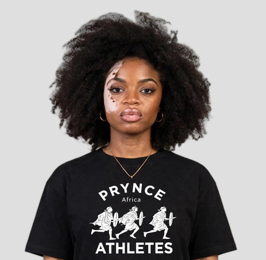 Woman wearing the PRYNCE Maasai Africa Athletes Tee in black with white PRYNCE Africa ATHLETES print, close-up