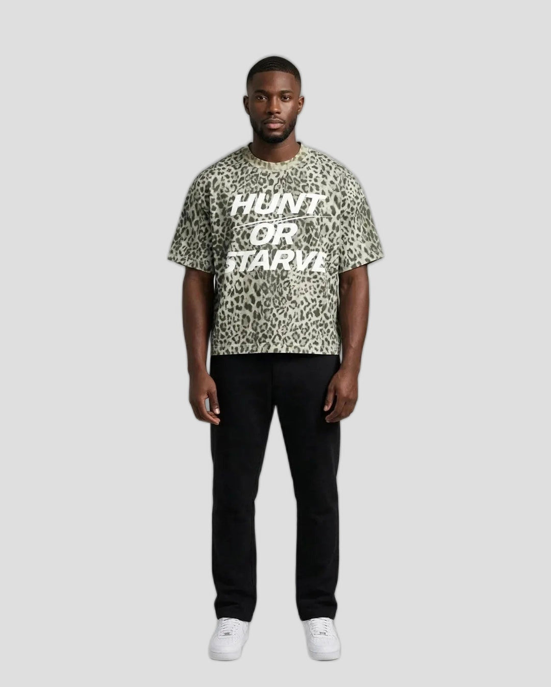 Chris wearing the PRYNCE Predator Boxy Tee — leopard print boxy t-shirt with white HUNT OR STARVE print