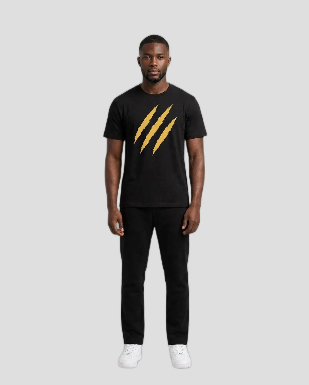 Chris wearing the PRYNCE Claw Marks Tee in black with gold claw marks on the chest, full body