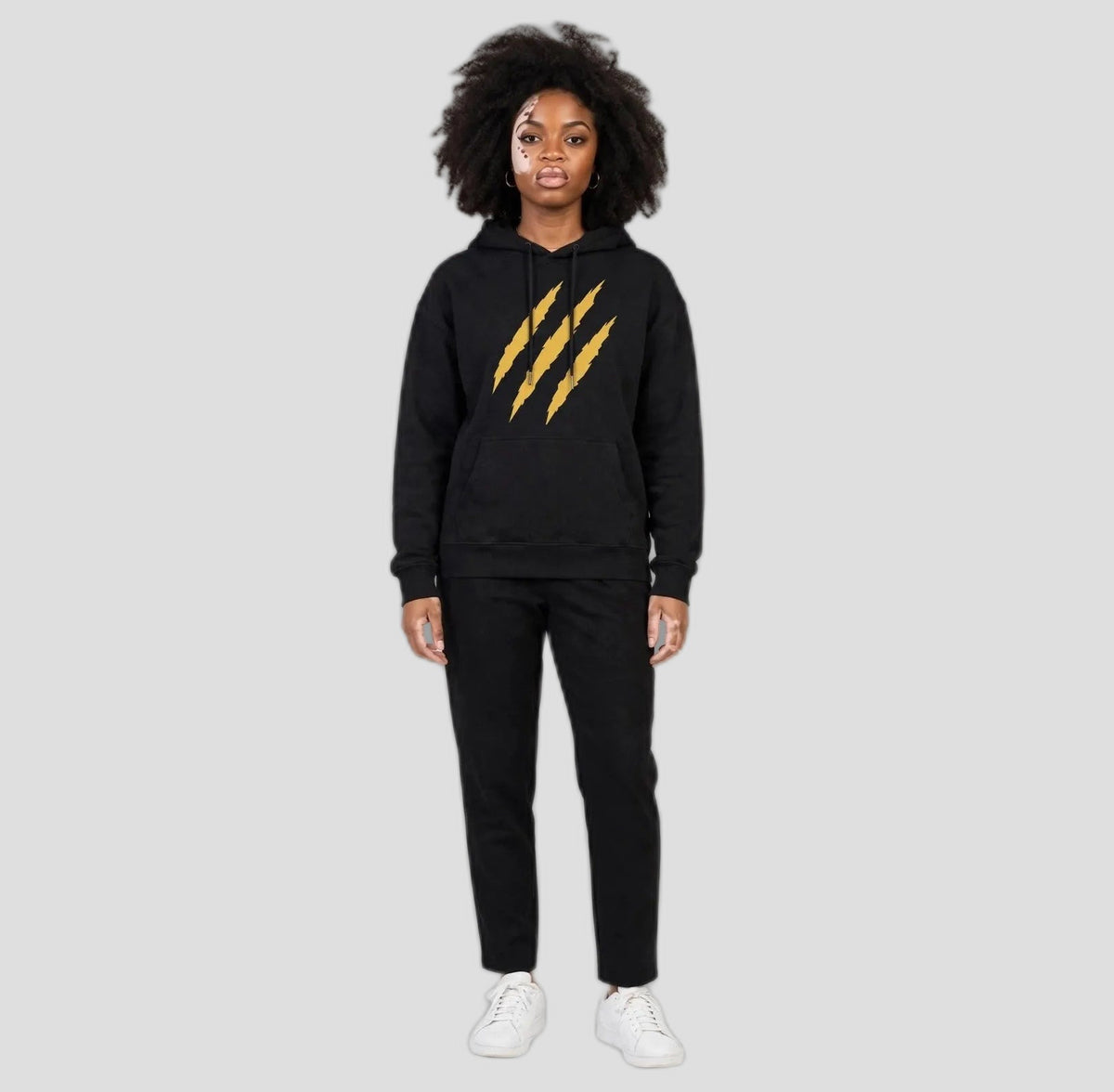 Camila wearing the PRYNCE Claw Marks Hoodie in black with gold claw marks on the chest, full body