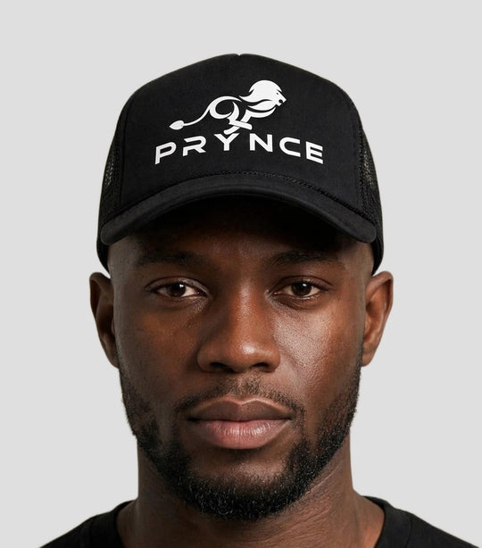 Chris wearing the PRYNCE White Lockup Foam Trucker Hat — black foam trucker hat with white running lion and PRYNCE lockup print