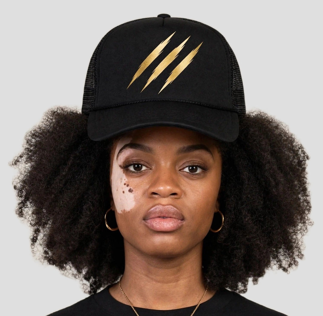 Camila wearing the PRYNCE Claw Marks Foam Trucker Hat — black foam trucker with gold claw marks print