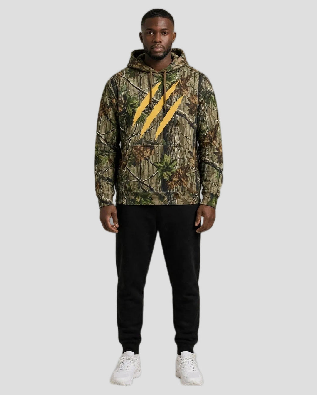 Chris wearing the PRYNCE Claw Marks Forest Camo Hoodie — heavyweight tree camo hoodie with large gold claw marks on the chest