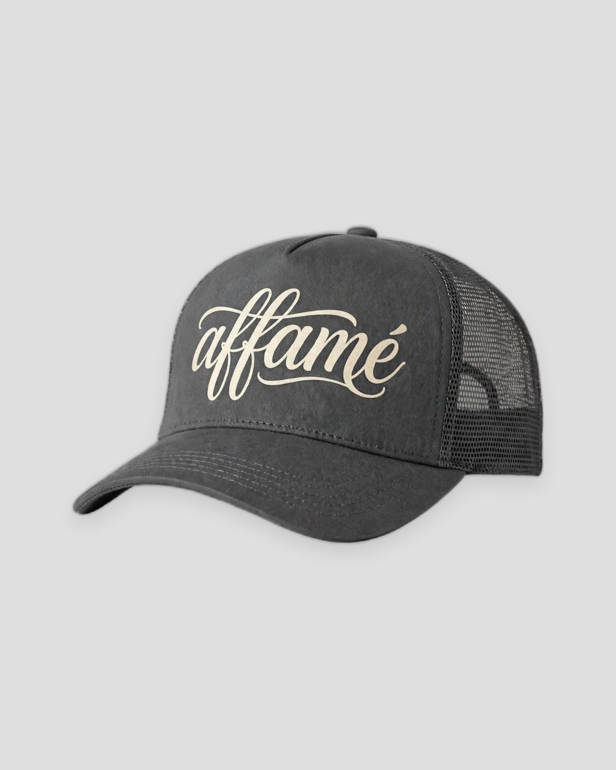 PRYNCE affamé Mesh Trucker Hat in charcoal with cream affamé script on the front
