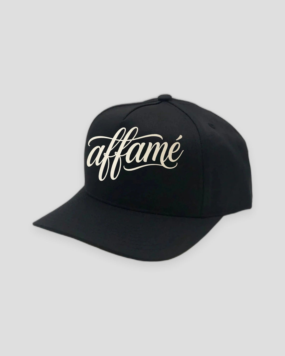 PRYNCE affamé Black Pro Cap — tall structured five-panel cap with cream affamé script on the front