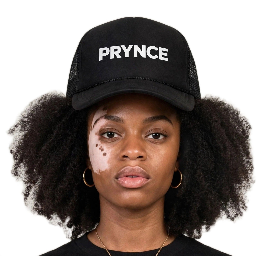Camila wearing the PRYNCE White Wordmark Foam Trucker Hat — black foam trucker hat with white PRYNCE wordmark print