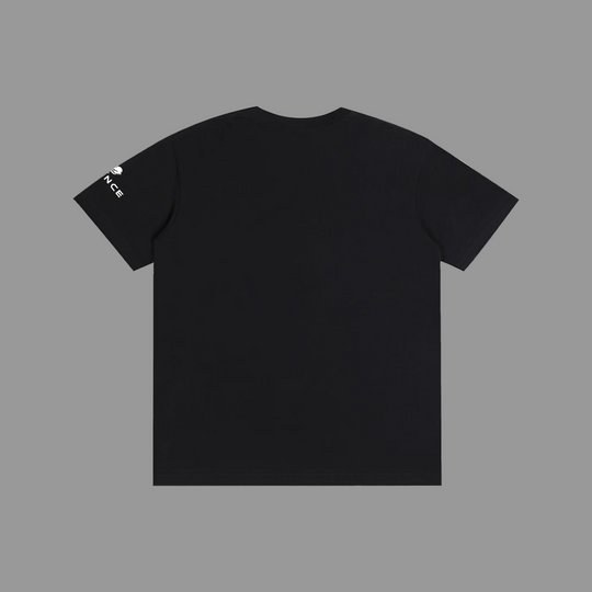 Black t-shirt with small white logos on sleeves against a grey background