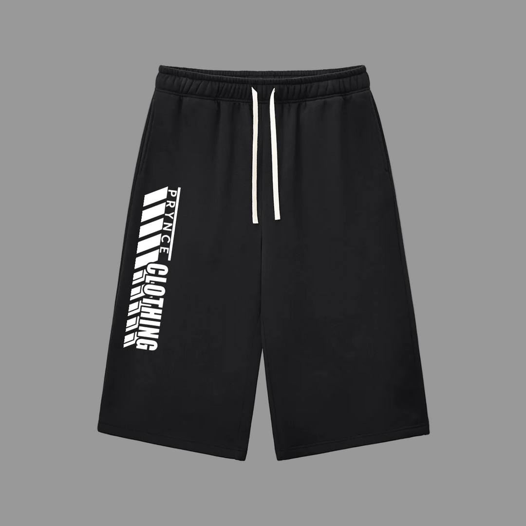 Black athletic shorts with a white drawstring and a bold white vertical graphic print on the left leg, displayed against a solid gray background.