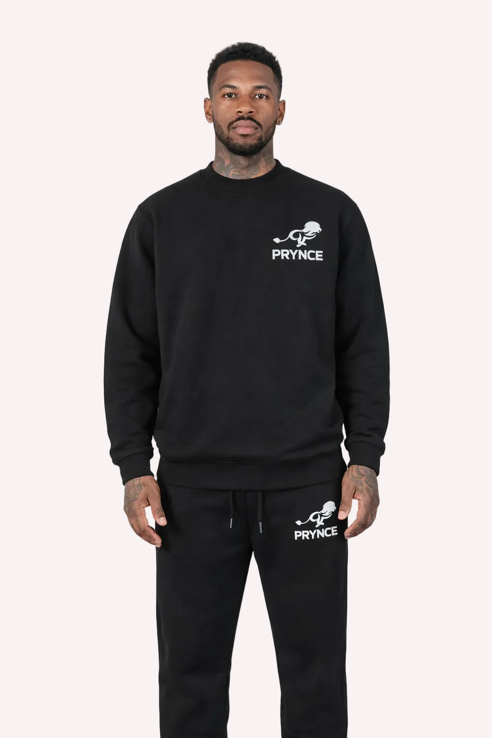 Man wearing a black sweatshirt and pants with 'Prynce' branding on a white background