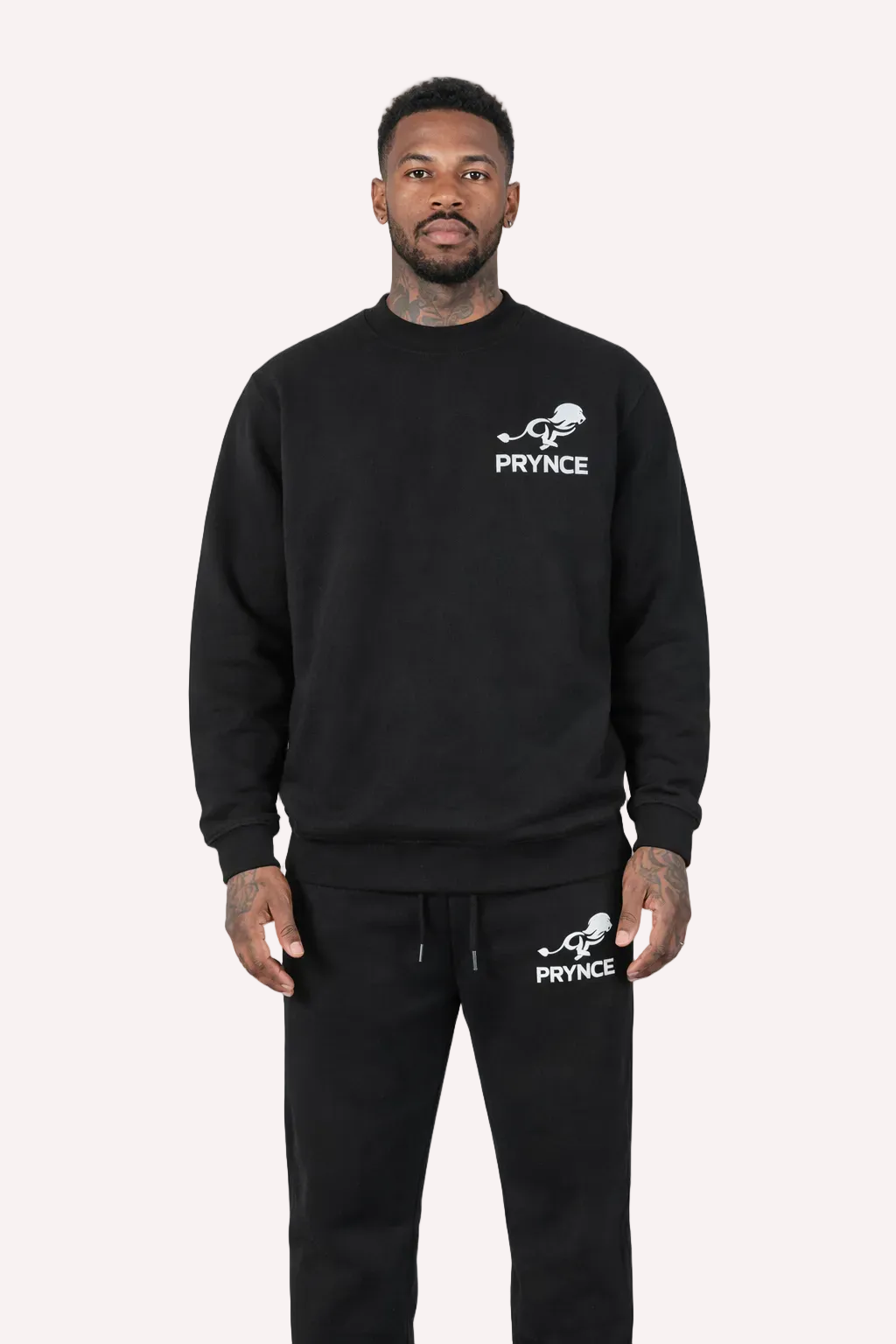 Man wearing a black sweatshirt and pants with &