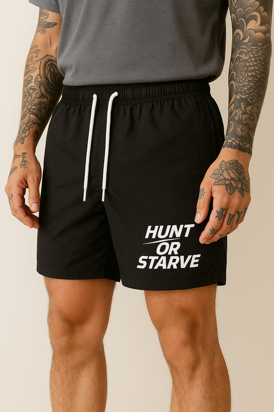 Person wearing black shorts with 'Hunt or Starve' text on a beige background