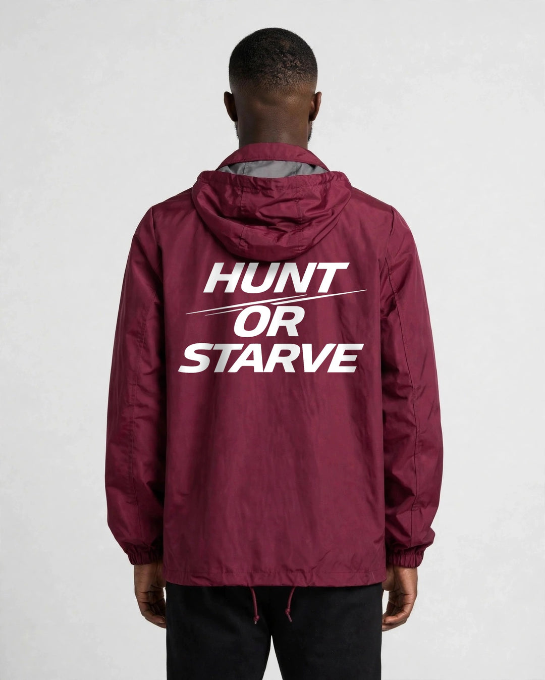 Hunt or Starve Hooded Windbreaker Jacket in burgundy, back view with large white HUNT OR STARVE print
