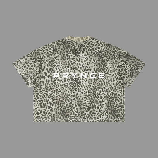A short-sleeve crop top t-shirt featuring an all-over leopard print pattern in olive green, gray, and black, with the word &