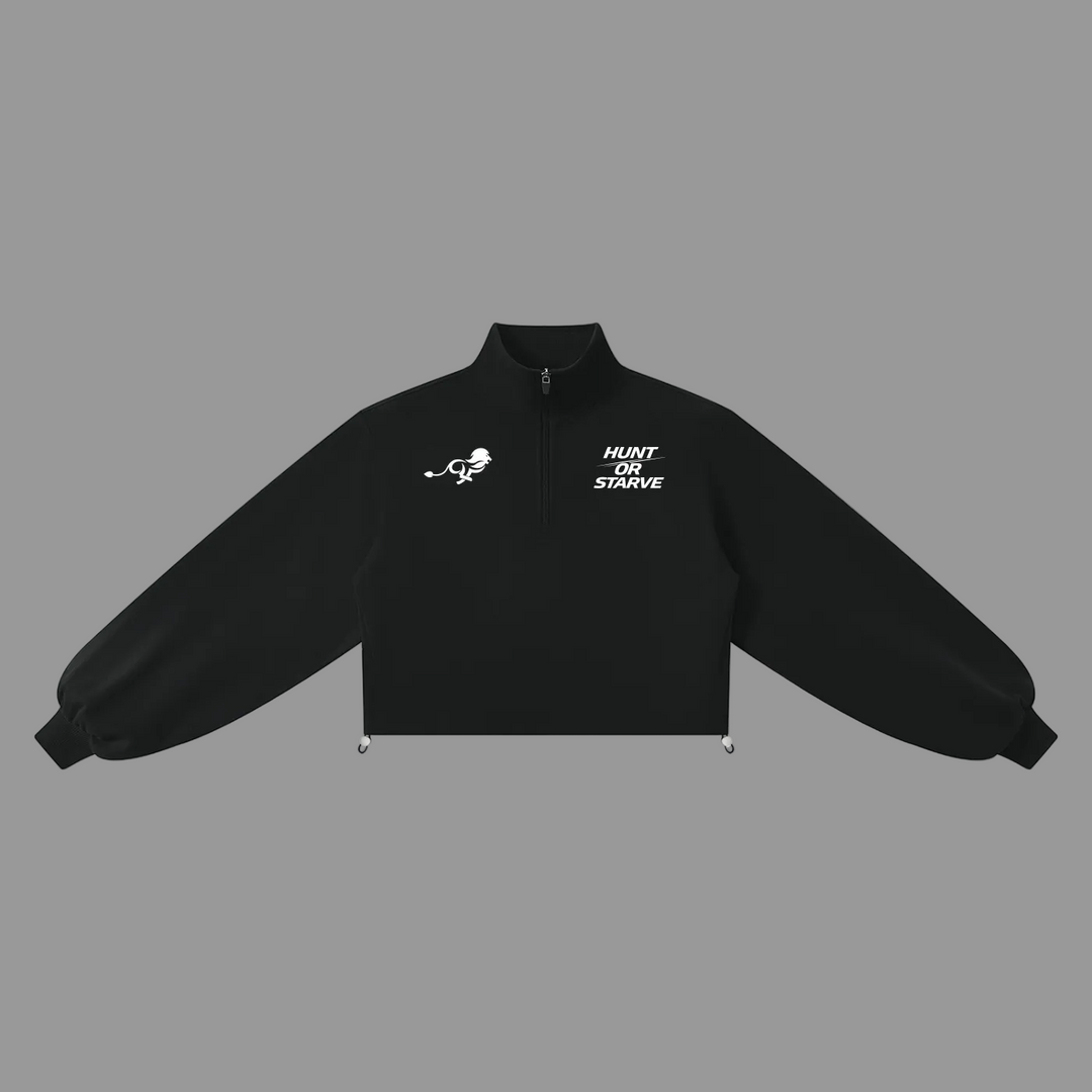 A black cropped quarter-zip jacket with white printed graphics on the chest, displayed flat against a solid white background.