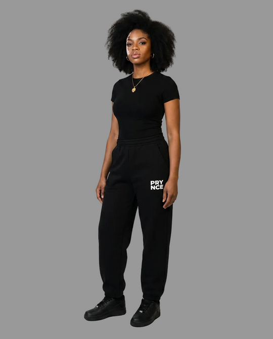 A woman modeling a black short-sleeve t-shirt and matching black sweatpants with a white &