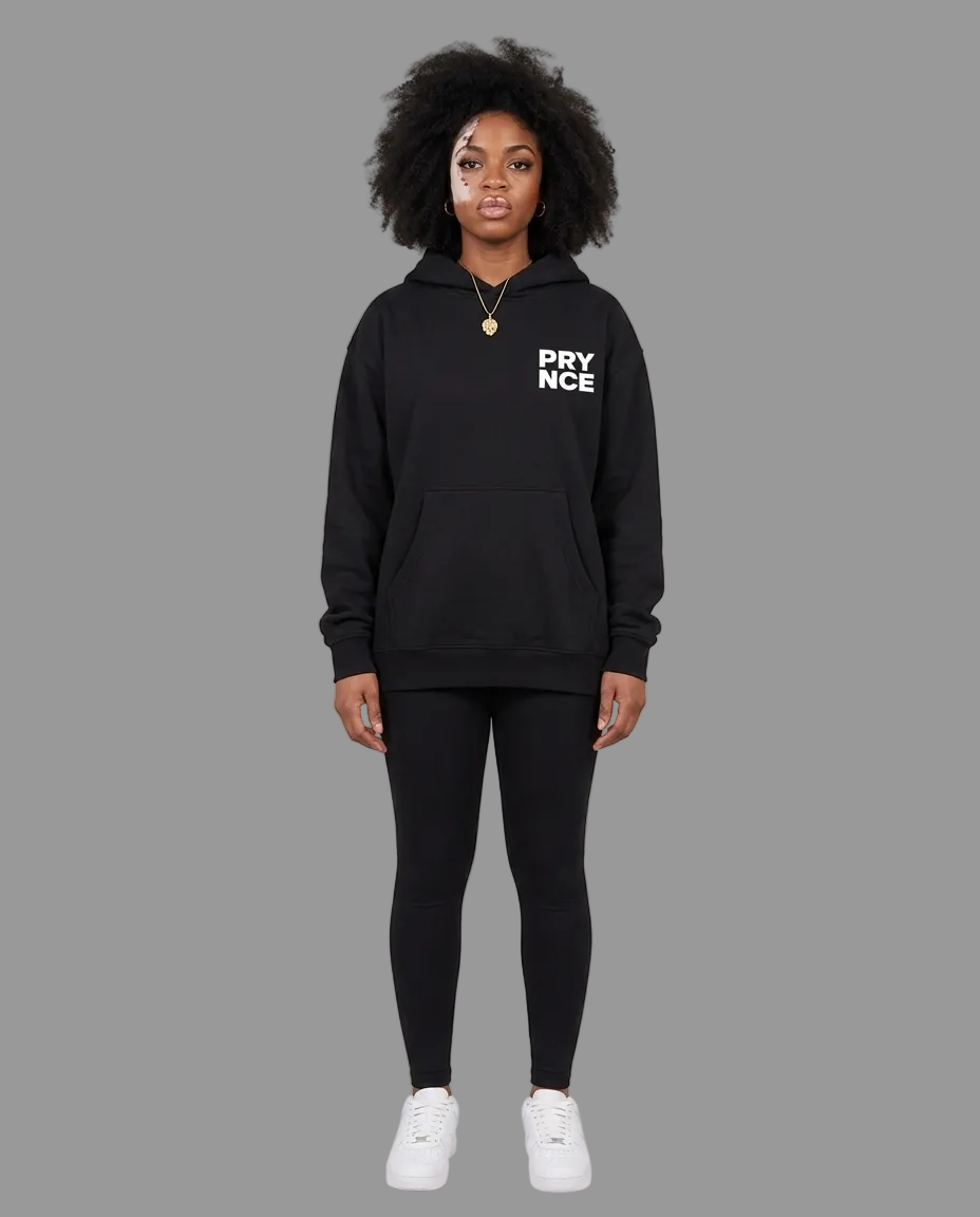 A model stands against a neutral beige studio background wearing a black pullover hoodie with &