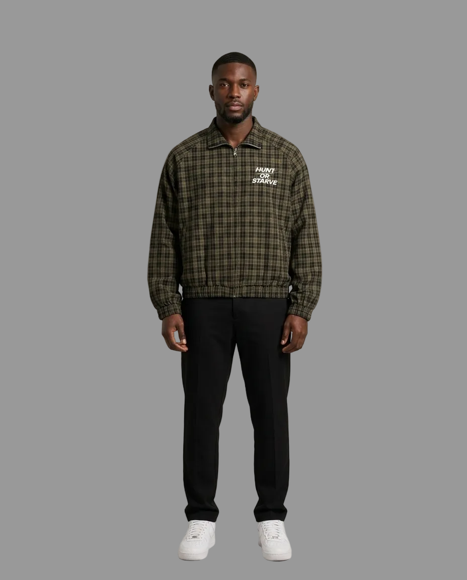 A man modeling a dark green and black plaid pullover jacket with white embroidered 'PONY RUNNER' text on the left chest, paired with black pants and white sneakers, against a solid light beige background.