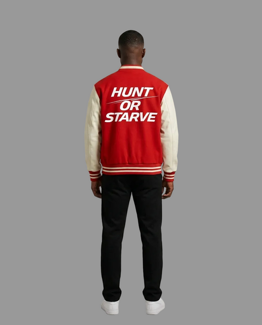 A man viewed from behind wearing a red and cream varsity jacket with the text &