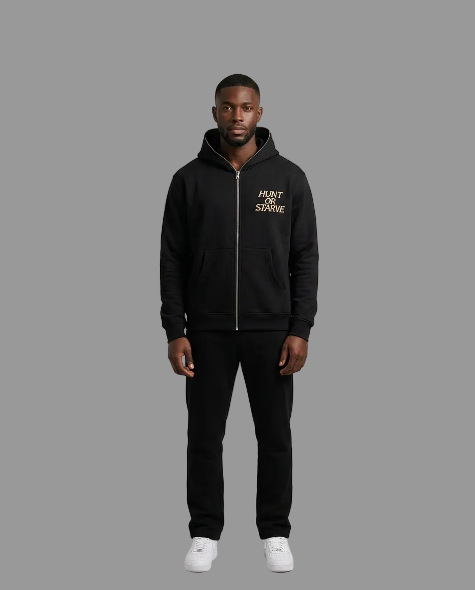 A man modeling a black zip-up hoodie with a gold &