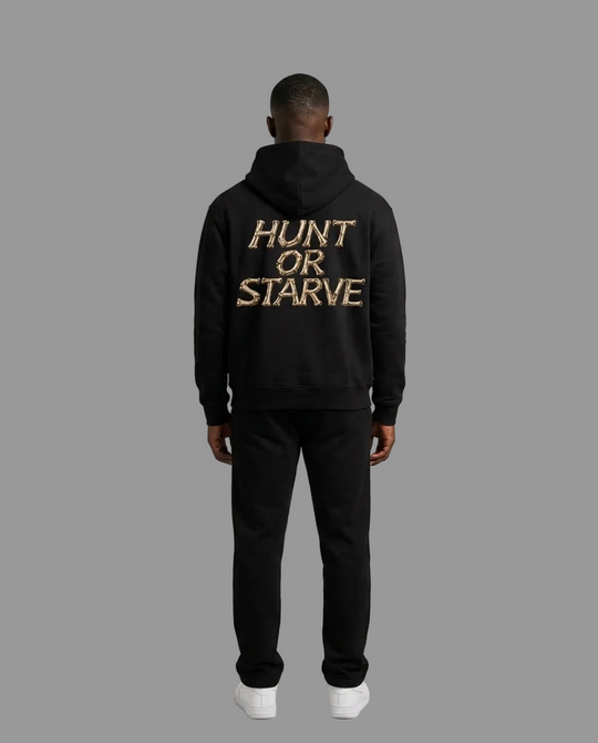 A man viewed from the back wearing a black hoodie with &