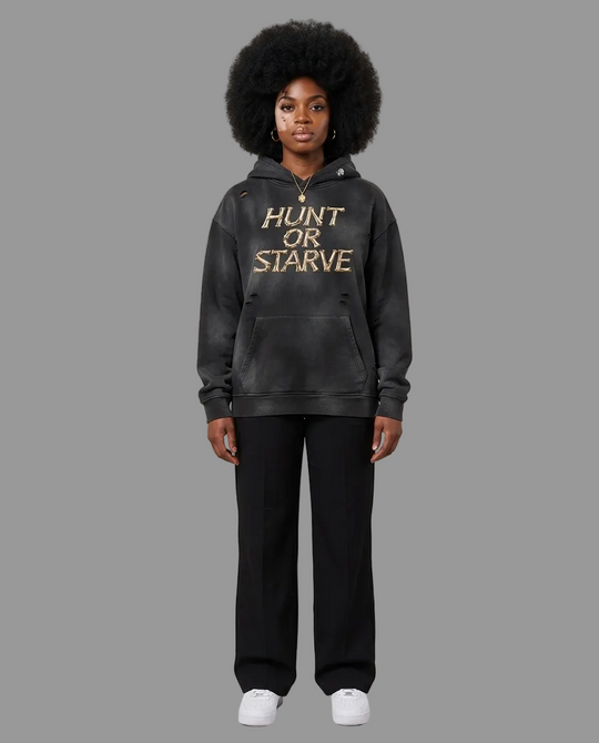 A model wearing a washed black pullover hoodie with &