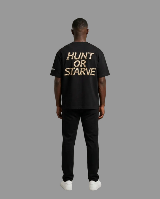 A man viewed from behind wearing a black t-shirt with &