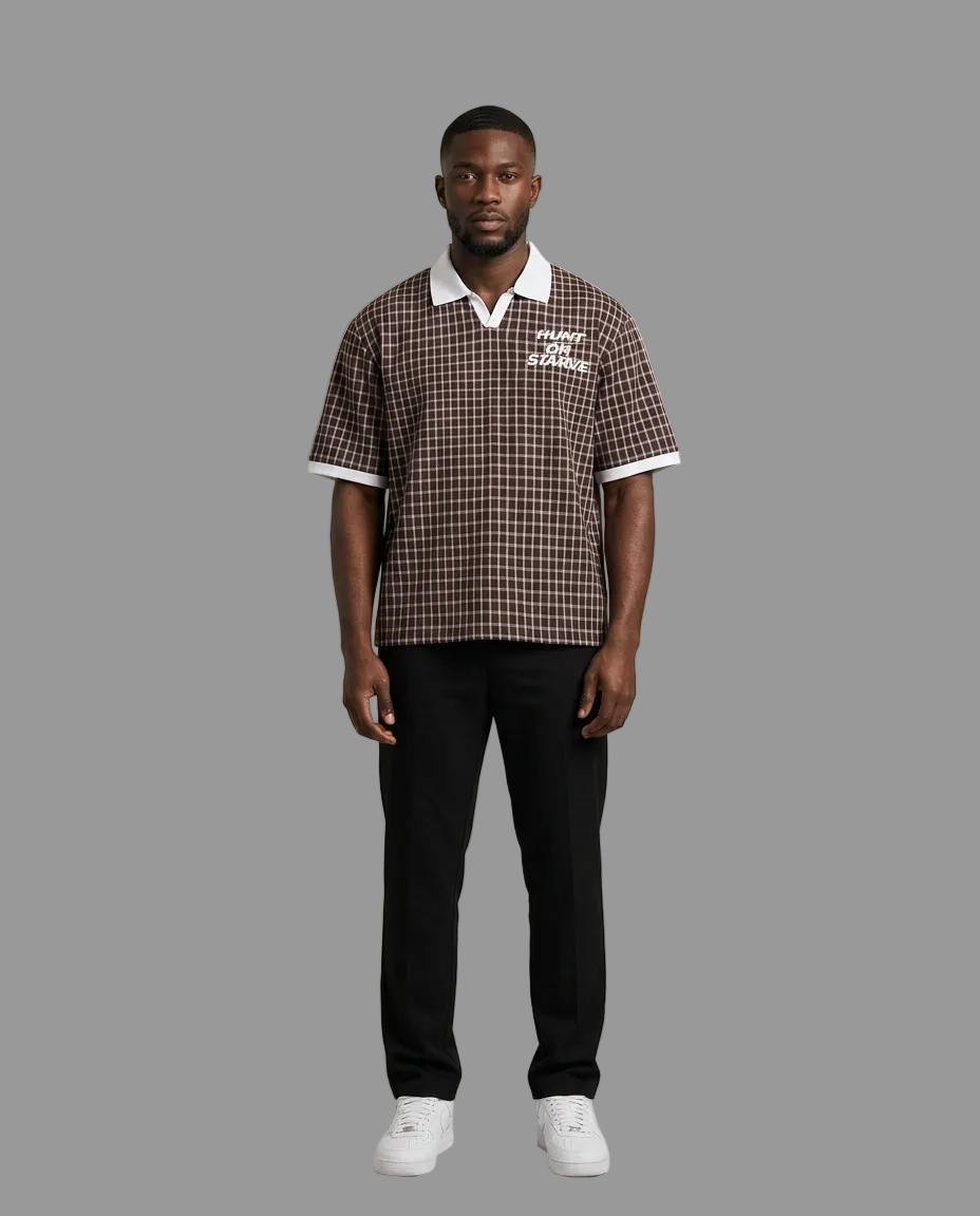 A man modeling a brown and white checkered short-sleeve polo shirt with a white collar and white sleeve trim, paired with black trousers and white sneakers, against a neutral beige background.