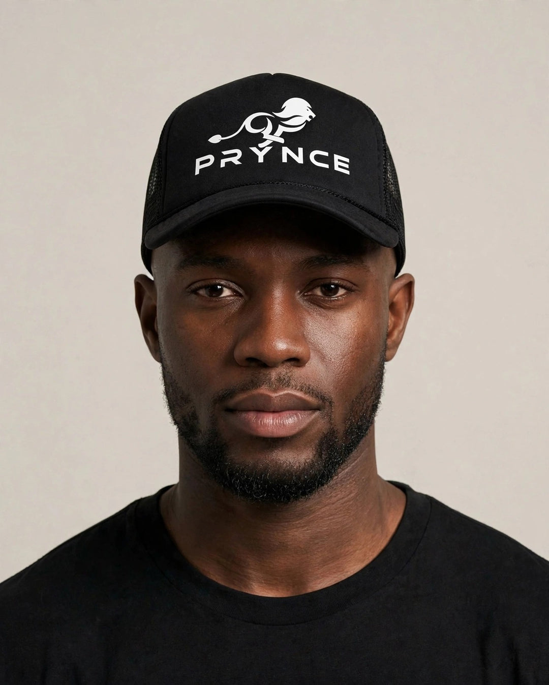 Chris wearing the PRYNCE White Lockup Foam Trucker Hat — black foam trucker hat with white running lion and PRYNCE lockup print