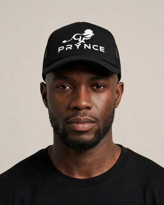 Chris wearing the PRYNCE White Lockup Foam Trucker Hat — black foam trucker hat with white running lion and PRYNCE lockup print