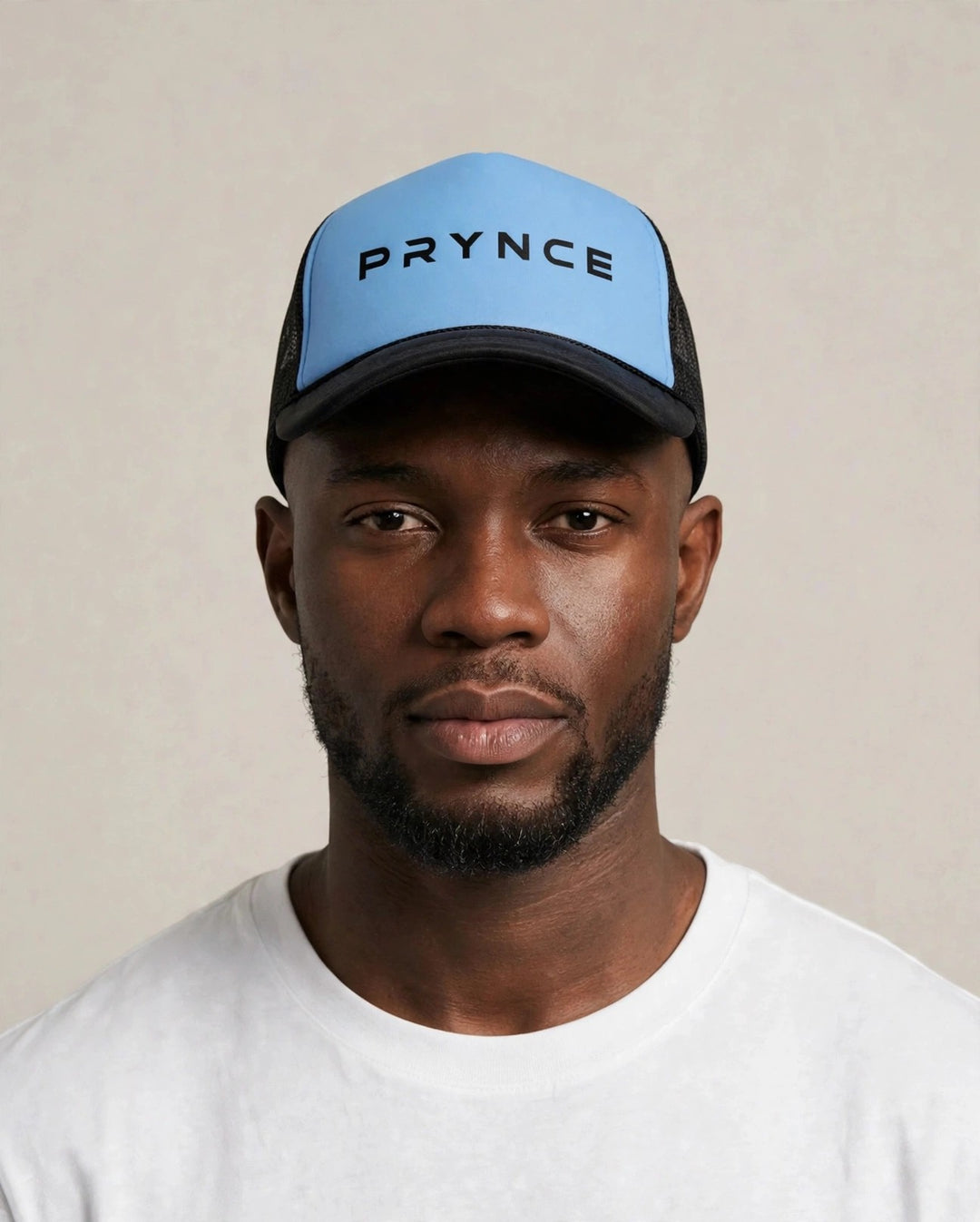 Chris wearing the PRYNCE Sky Wordmark Foam Trucker Hat — sky blue foam trucker hat with black PRYNCE wordmark print