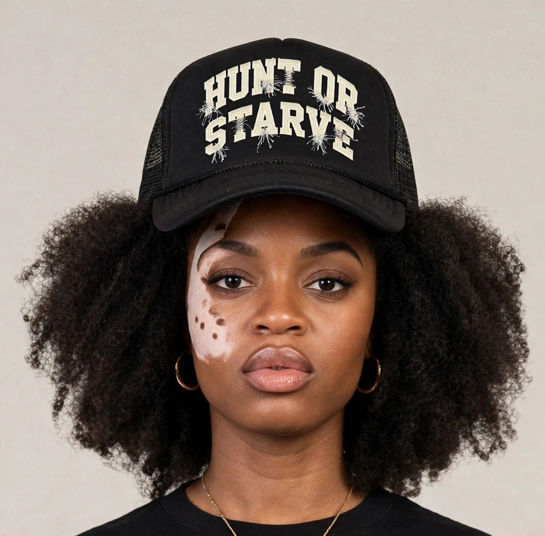 Camila wearing the Hunt or Starve Varsity Foam Trucker Hat — black foam trucker hat with cream varsity HUNT OR STARVE arch print