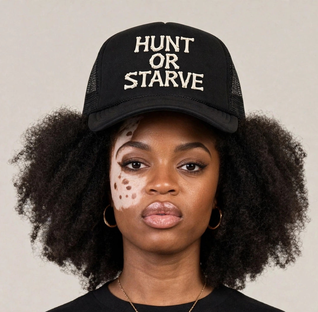 Camila wearing the Hunt or Starve Bones Foam Trucker Hat — black foam trucker hat with HUNT OR STARVE bone letters print