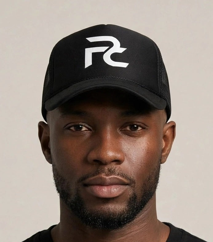 Chris wearing the PRYNCE PC Monogram Foam Trucker Hat — black foam trucker hat with white interlocked PC monogram print