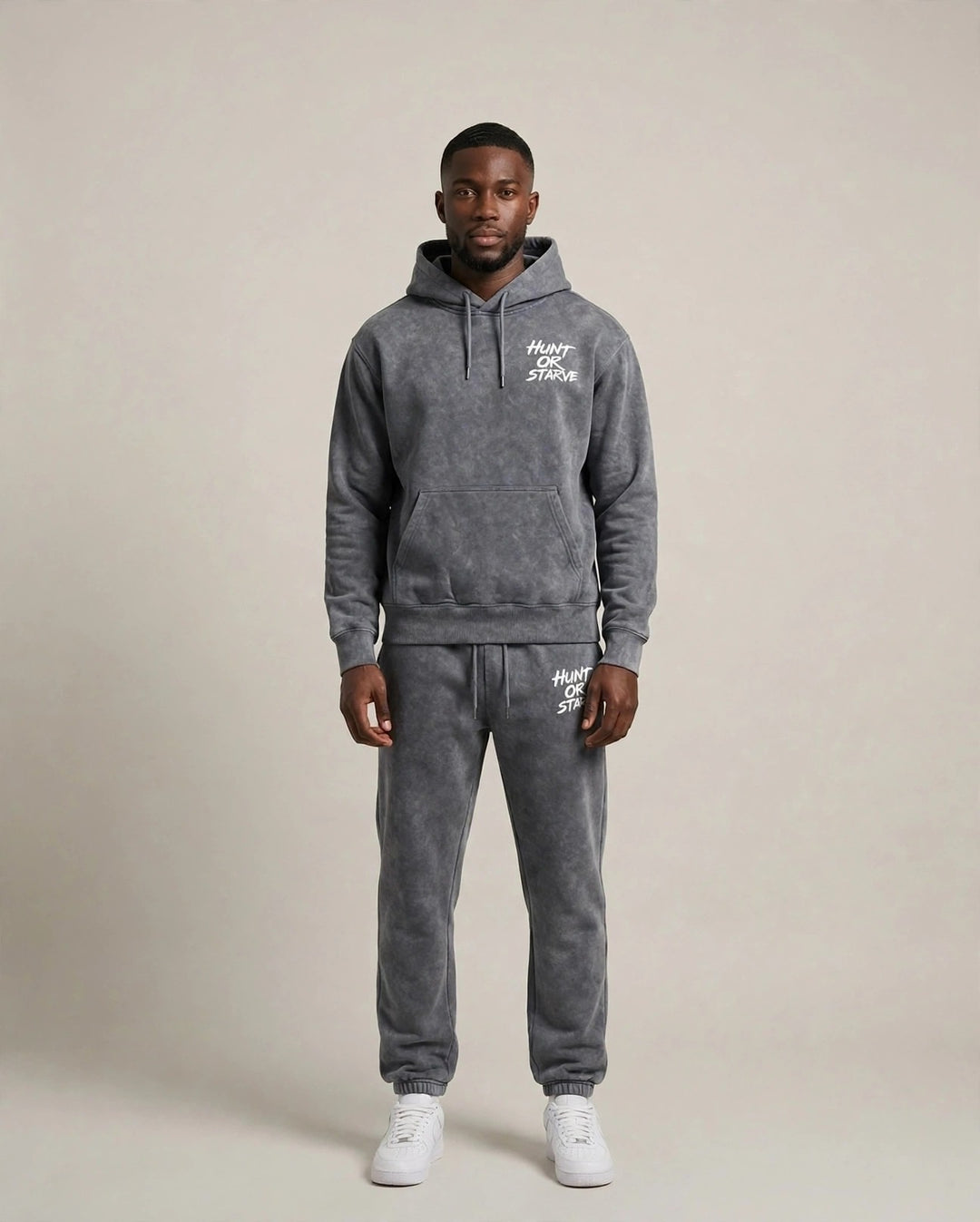 Chris wearing the Endurance H.O.S Mineral Wash Set — grey mineral wash hoodie and sweatpants with Hunt or Starve hits