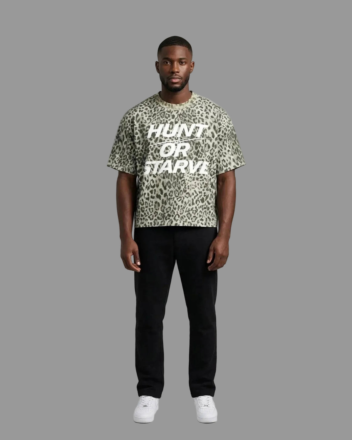 Chris wearing the PRYNCE Predator Boxy Tee — leopard print boxy t-shirt with white HUNT OR STARVE print